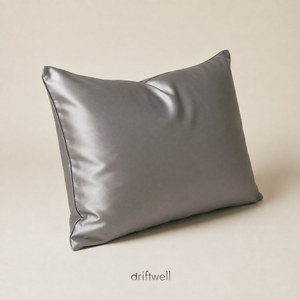 Driftwell 100% mulberry silk pillowcase in dark gray, on a plain bone background