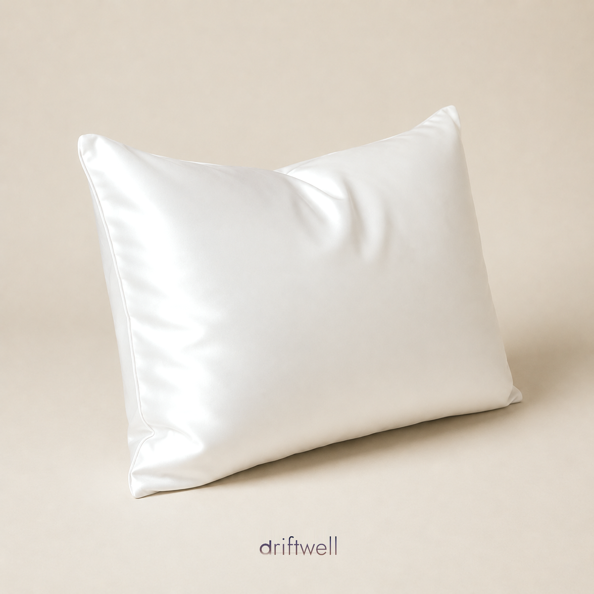 Driftwell 100% mulberry silk pillowcase in white, on a plain bone background